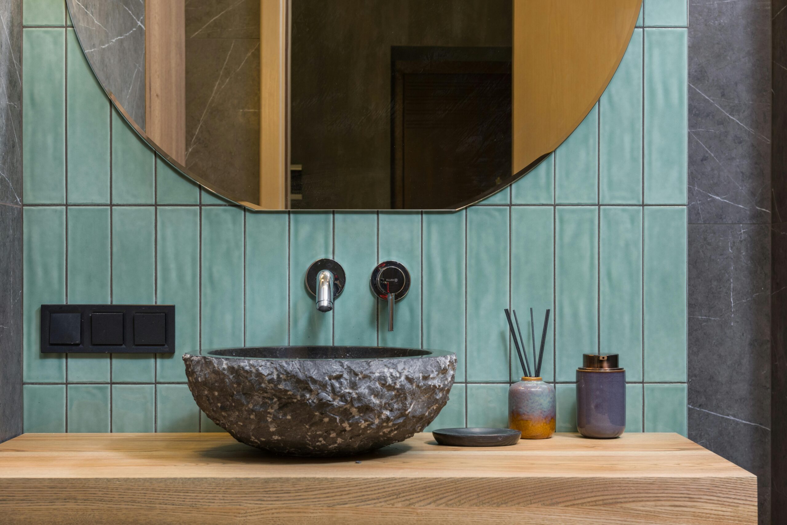 Elegant bathroom featuring a stone washbasin and minimalist design.